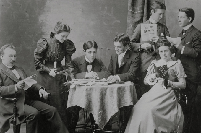 Group of students work on the student newspaper in the 1800s