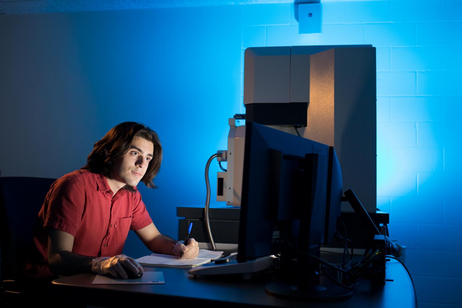 Student using an electron microscope