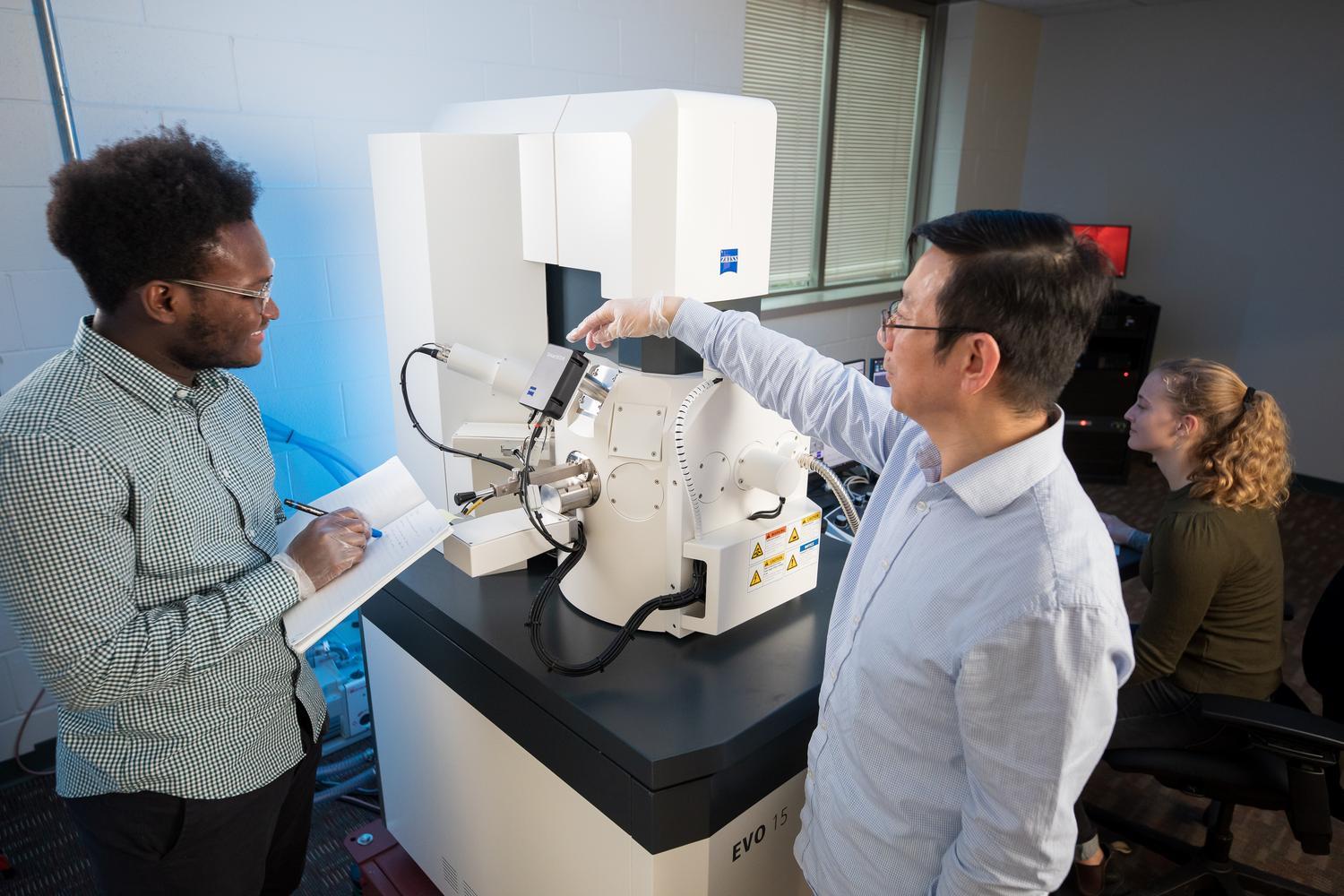 Professor Lifeng Dong, Physics, with Hamline's Electron Microscope