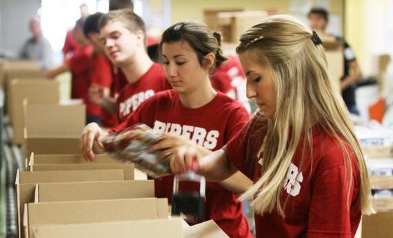 Three Hamline student wearing red 